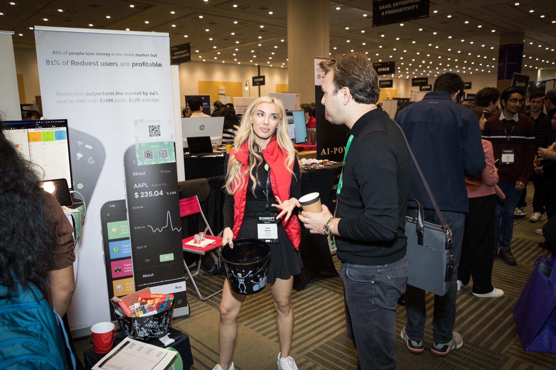 Anya Ozmen introducing the Redvest stock market game to an attendee at TechCrunch Disrupt
